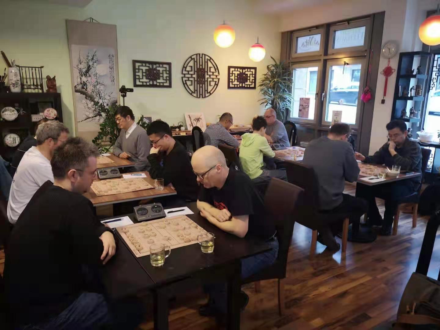 Playing Xiangqi in Germany. IGM Xue Handi is in the background.